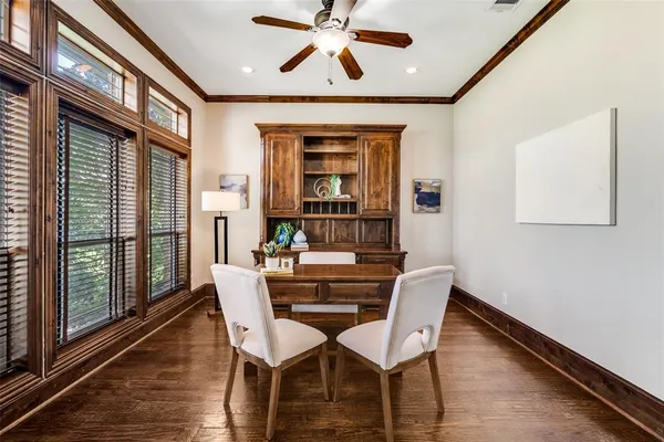 a dining room with furniture window and wooden floor