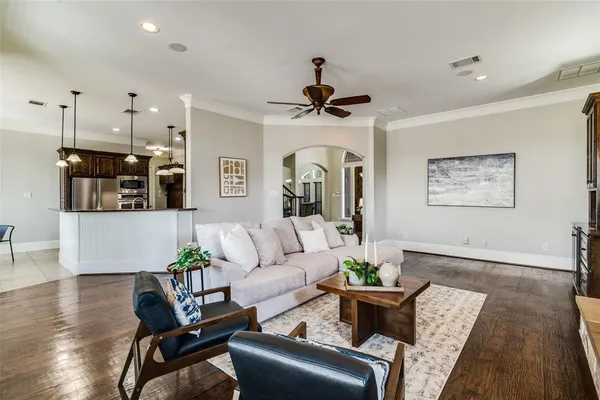a living room with furniture and a chandelier