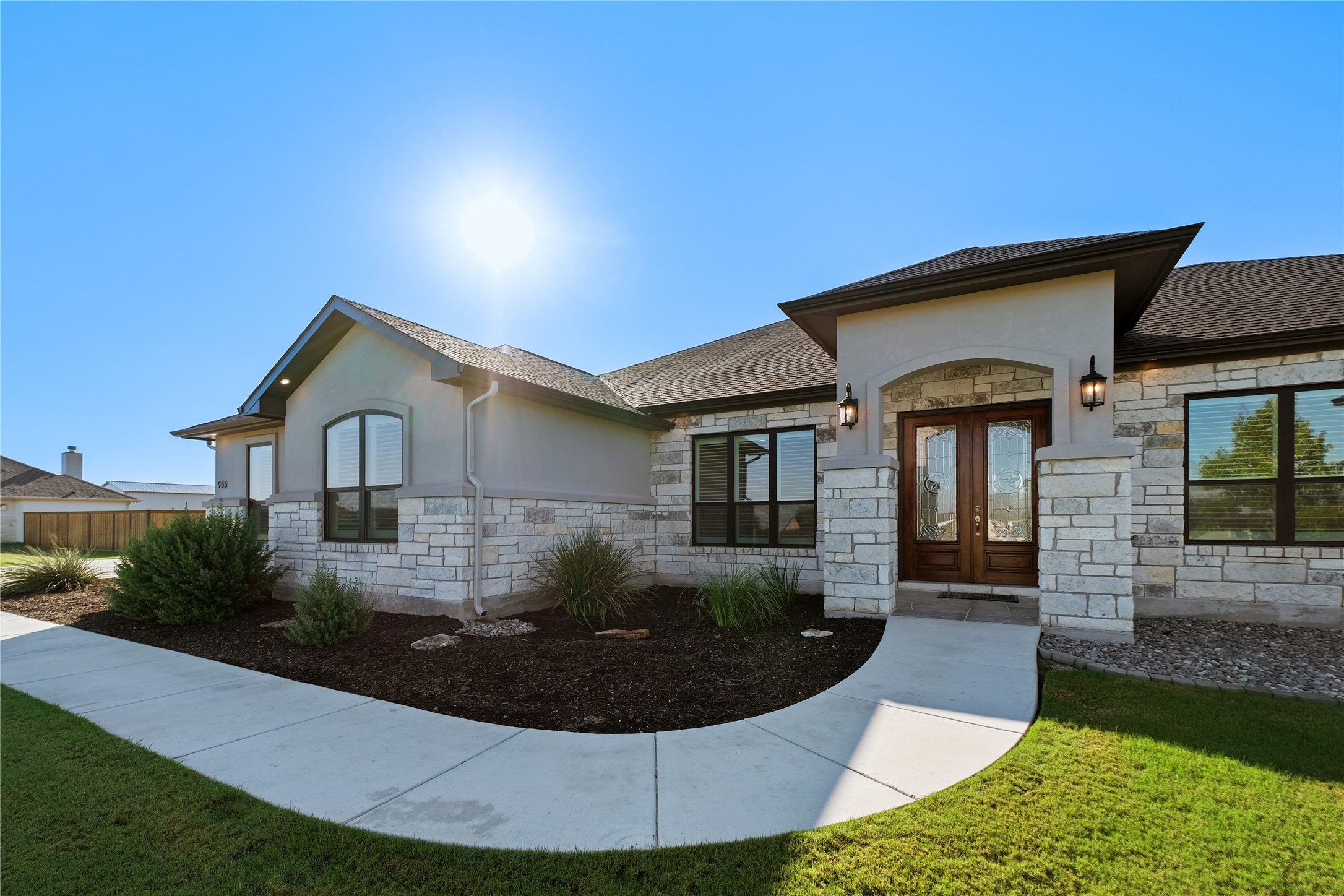 955 Inka Road Salado, TX 76571 - Photo 1 of 39 Natural stone masonry and a concrete walkway lead to the recessed double-door entryway.