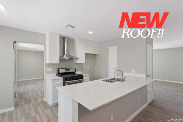 a kitchen with kitchen island a counter top space and stainless steel appliances