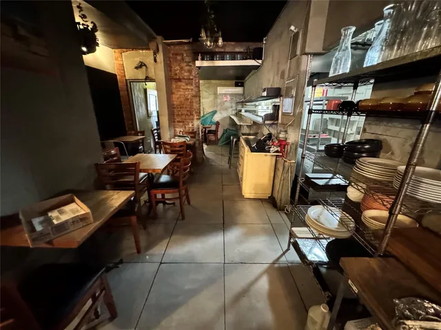 a utility room with stainless steel appliances and living room