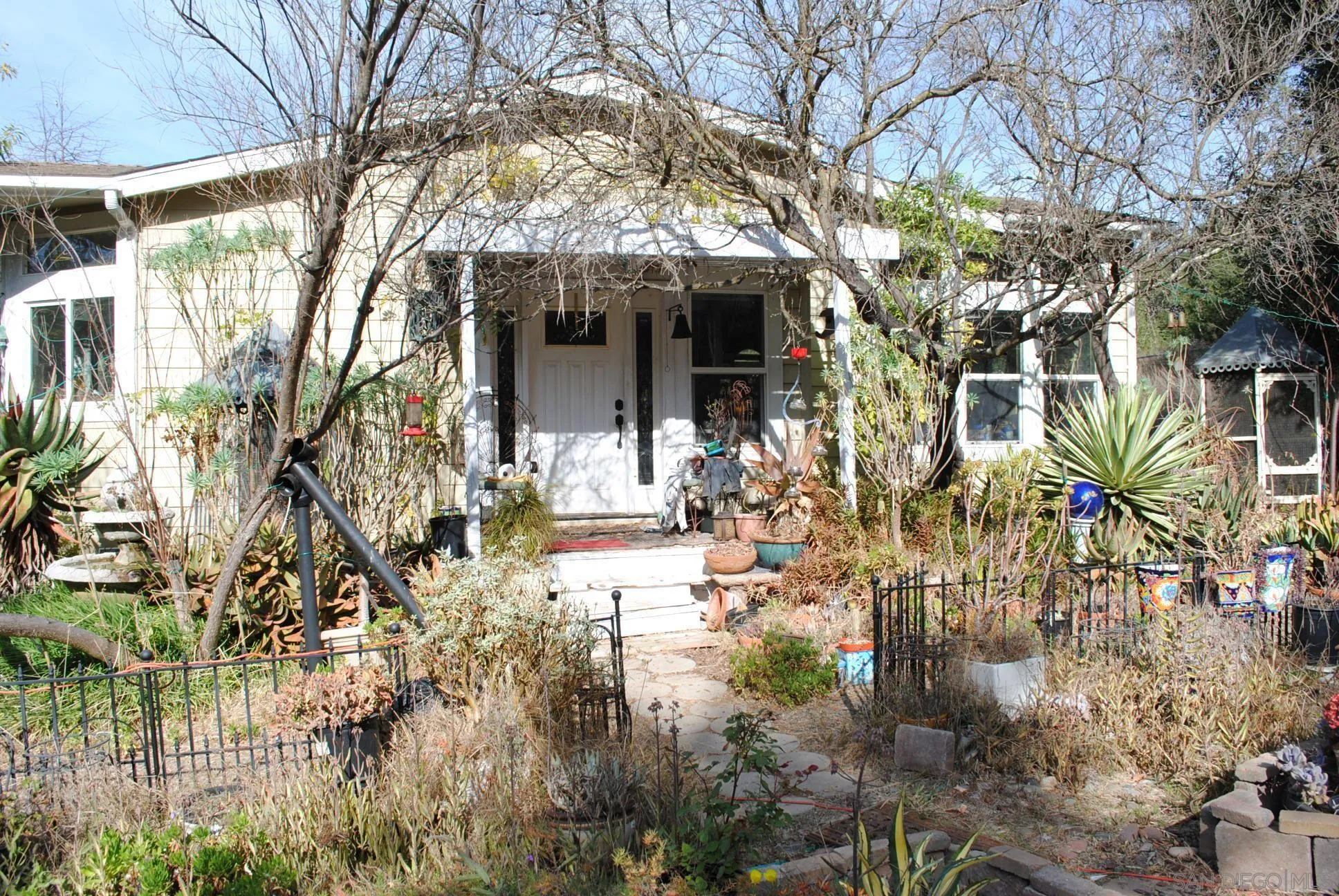 a view of house with yard and sitting area