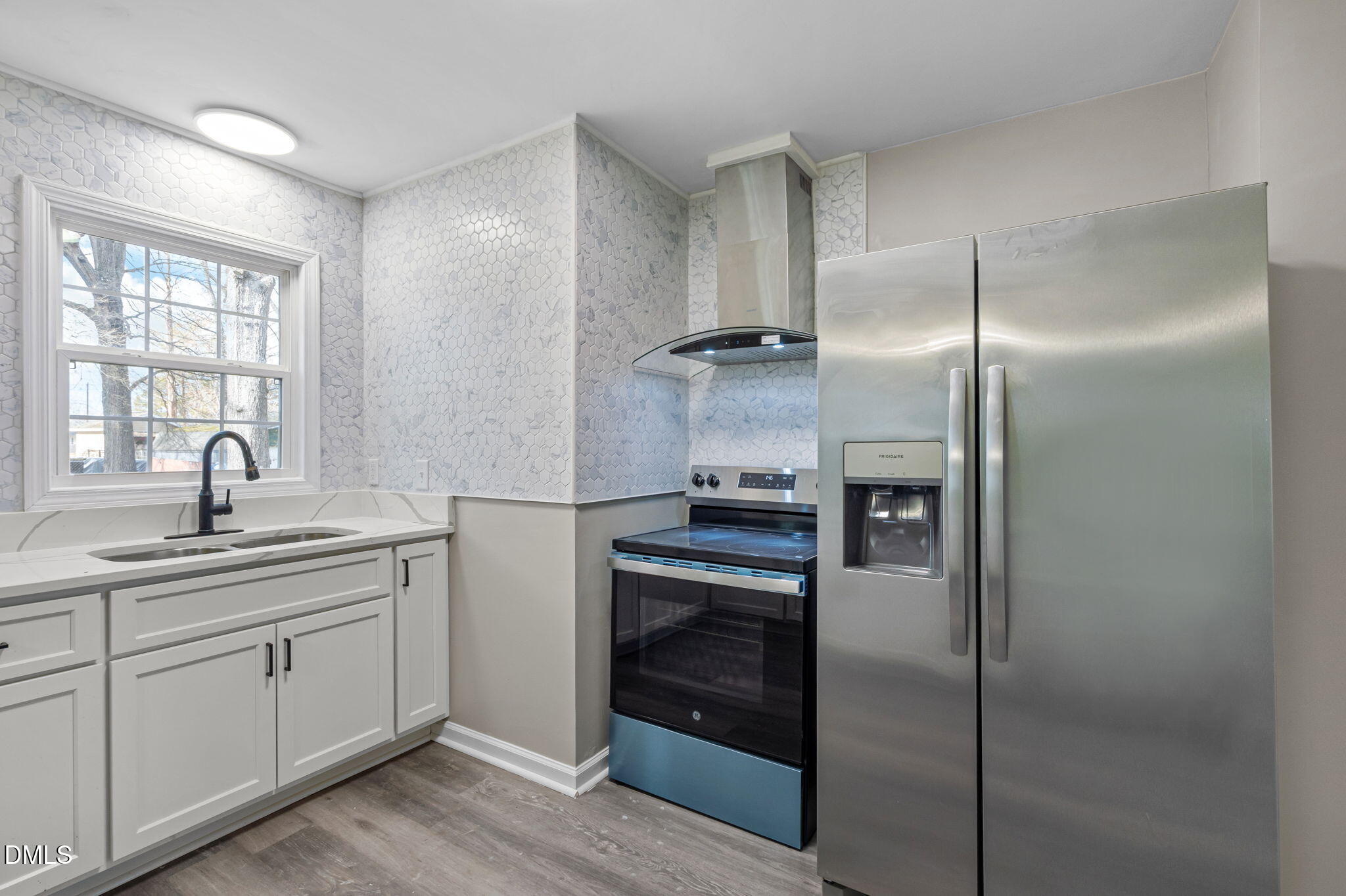 42 South 2nd Street Roxboro, NC 27573 - Photo 11 of 26 a kitchen with a sink and stainless steel appliances