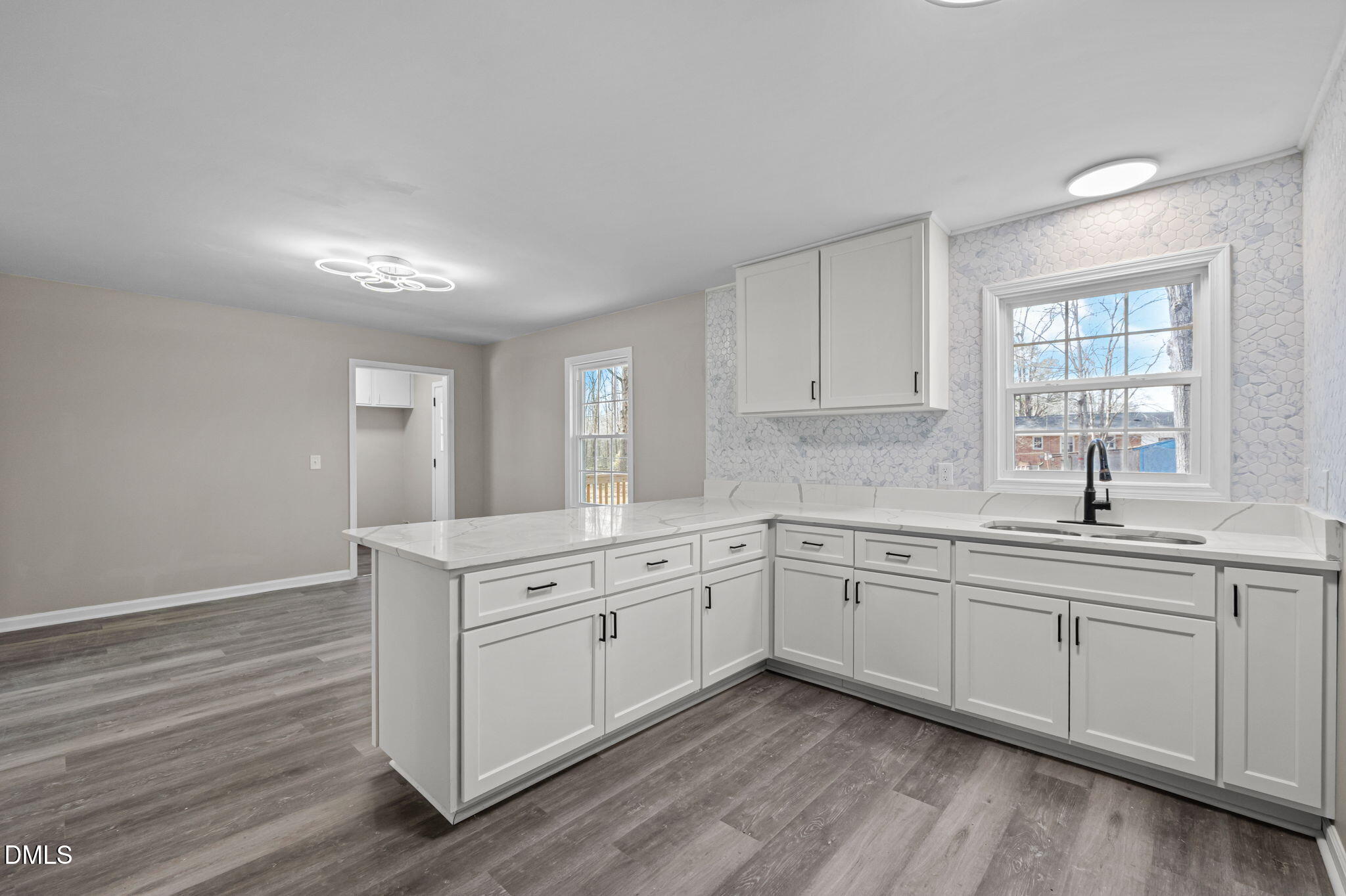 42 South 2nd Street Roxboro, NC 27573 - Photo 12 of 26 a kitchen with a sink cabinets and wooden floor