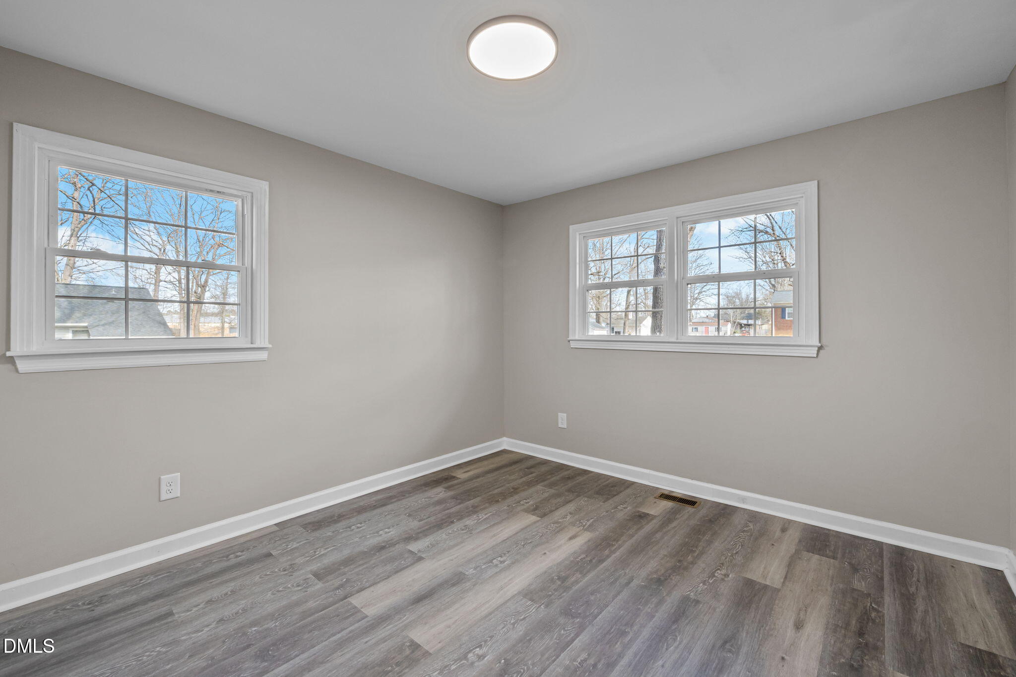 42 South 2nd Street Roxboro, NC 27573 - Photo 20 of 26 an empty room with wooden floor and windows