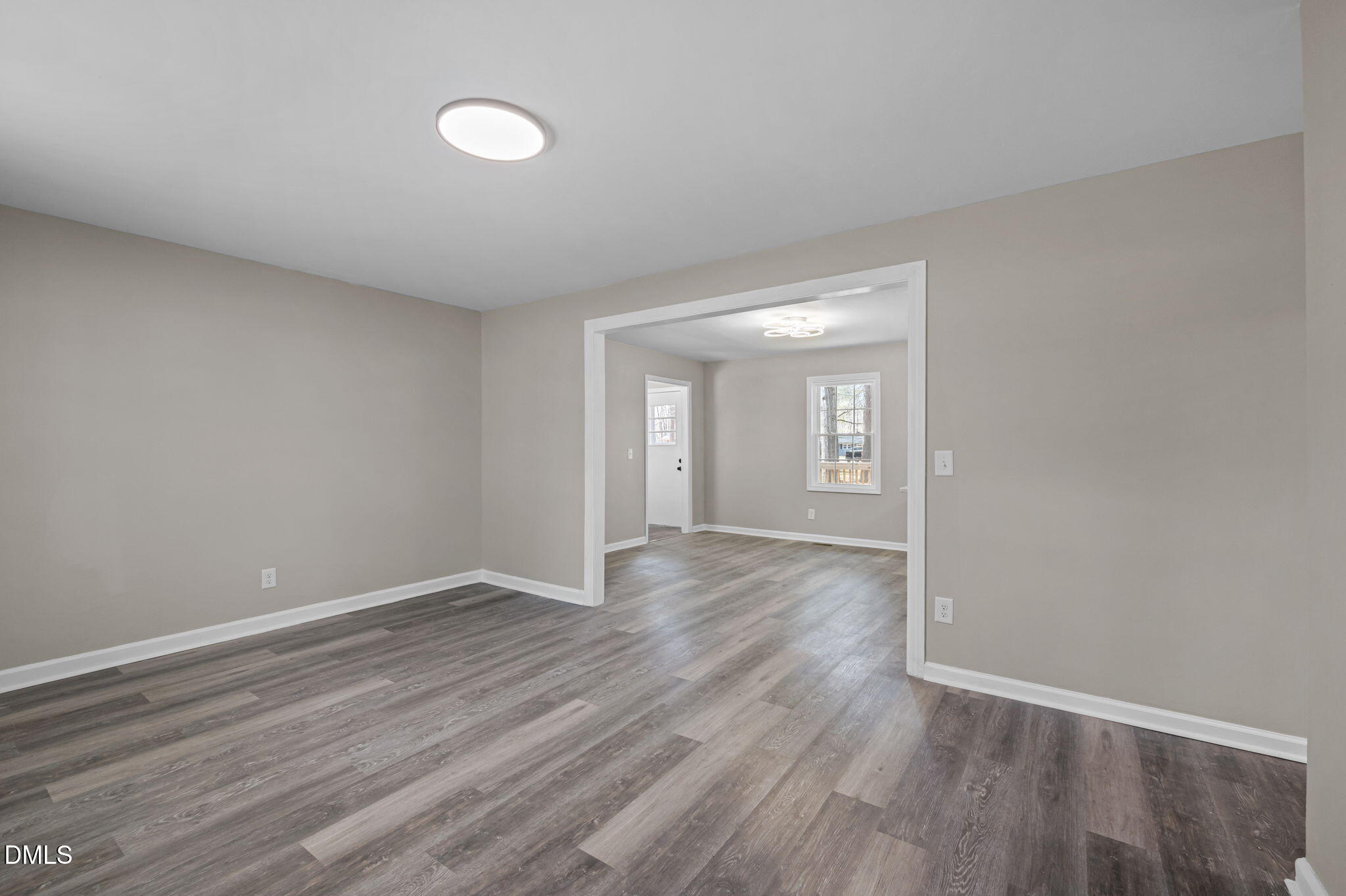 42 South 2nd Street Roxboro, NC 27573 - Photo 3 of 26 a view of an empty room with wooden floor and window