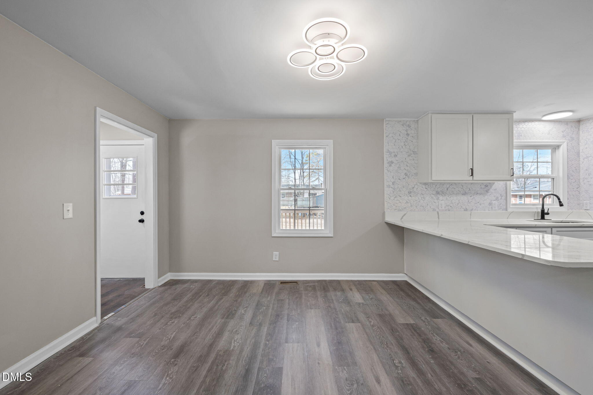 42 South 2nd Street Roxboro, NC 27573 - Photo 6 of 26 a view of a kitchen with a sink and wooden floor