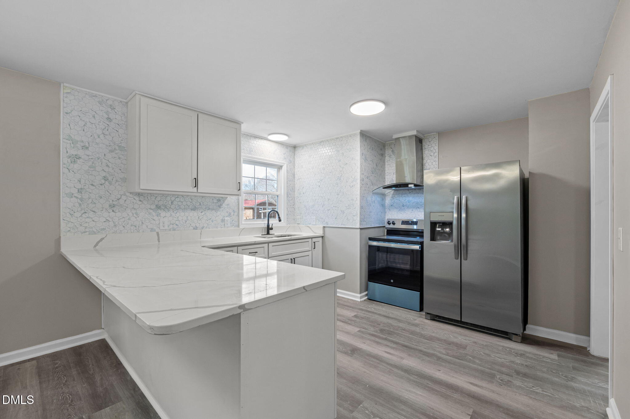 42 South 2nd Street Roxboro, NC 27573 - Photo 9 of 26 a kitchen with a refrigerator sink and cabinets