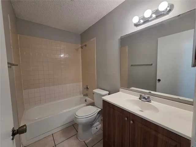 a bathroom with a bathtub a sink a toilet a mirror and shower