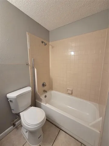 a bathroom with a toilet and a bathtub