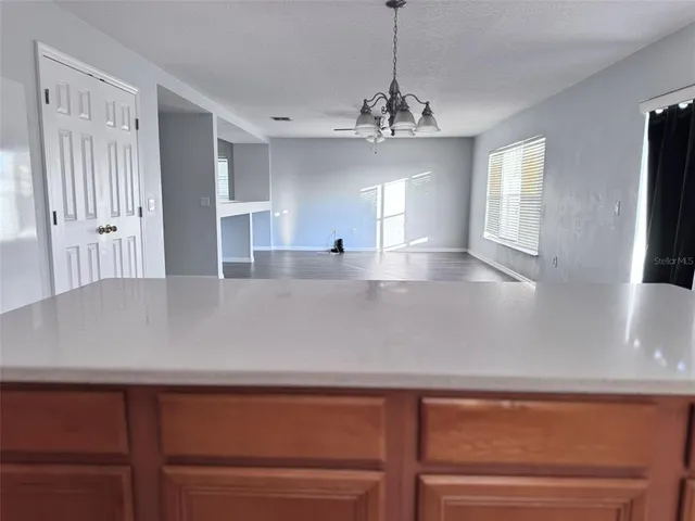 a view of a center island wooden floor and a living room