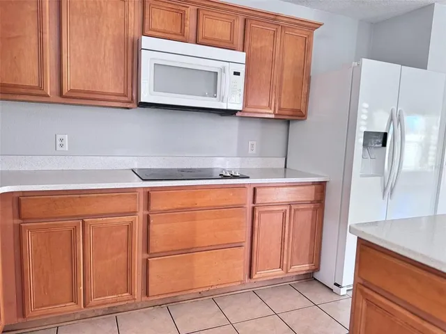 a kitchen with stainless steel appliances granite countertop a refrigerator and cabinets