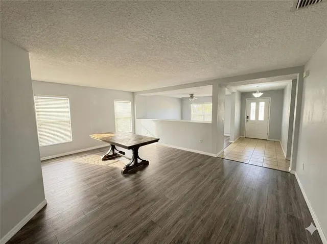 an empty room with wooden floor and a window
