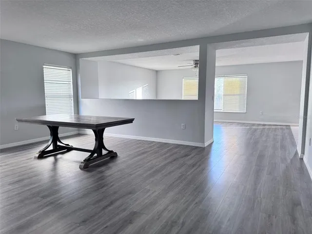 a view of a room with wooden floor a table and chair