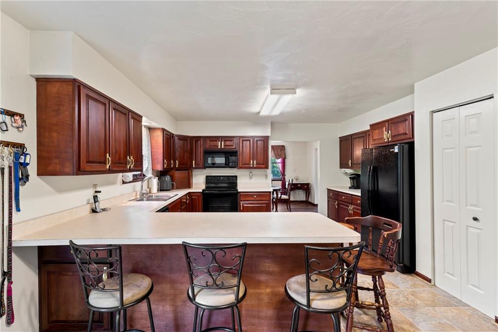 20 Sturge Hollow Road Amity, PA 15311 - Photo 10 of 30 a kitchen with stainless steel appliances a dining table and chairs