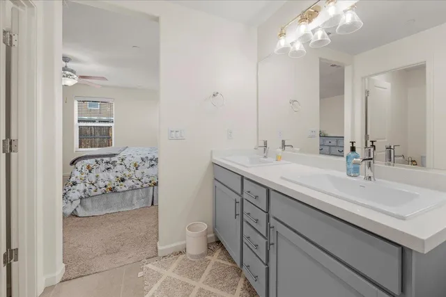a bathroom with a sink double vanity and a mirror