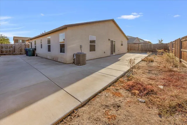 a view of white house with a large parking space