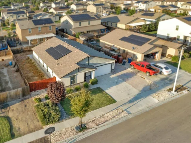 an aerial view of residential houses with outdoor space