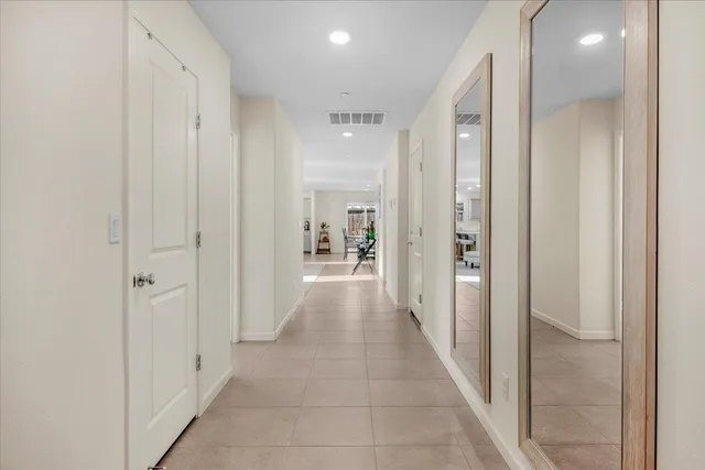 a view of a hallway with a livingroom and a bathroom