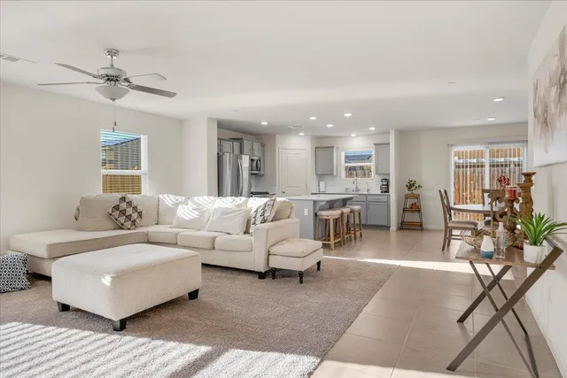 a living room with furniture and a view of kitchen