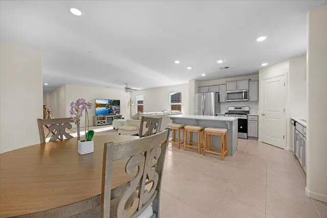 a large kitchen with a table and chairs