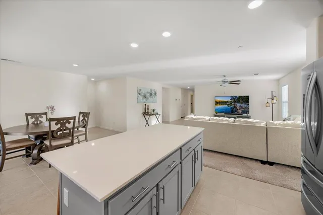 a kitchen with a table chairs and a refrigerator