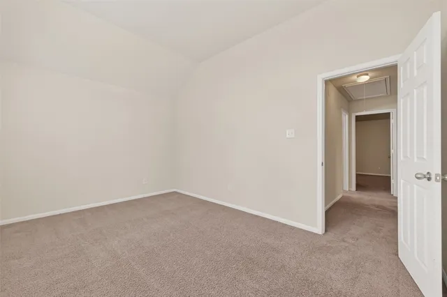 a view of an empty room and closet area