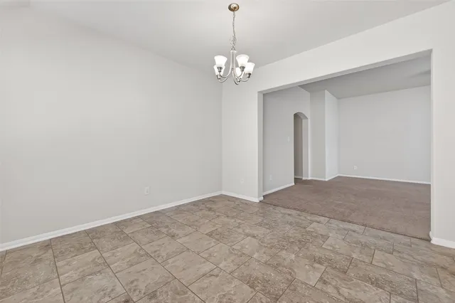 a view of a chandelier in big room and chandelier