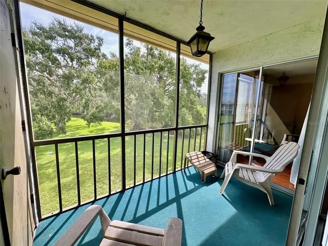 a view of two chairs in a balcony