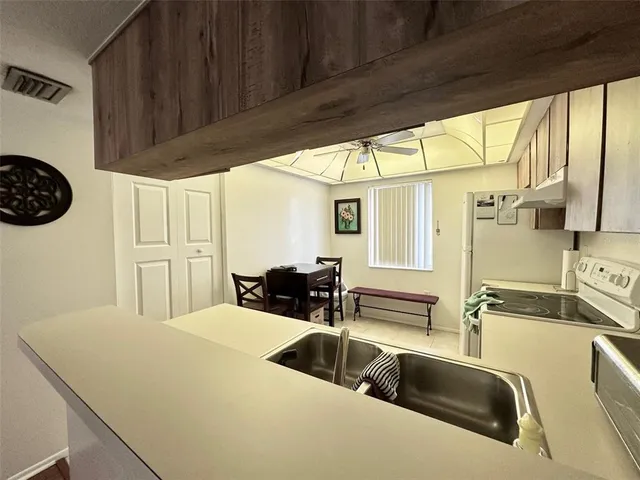 a kitchen with a sink a counter top space and a large window