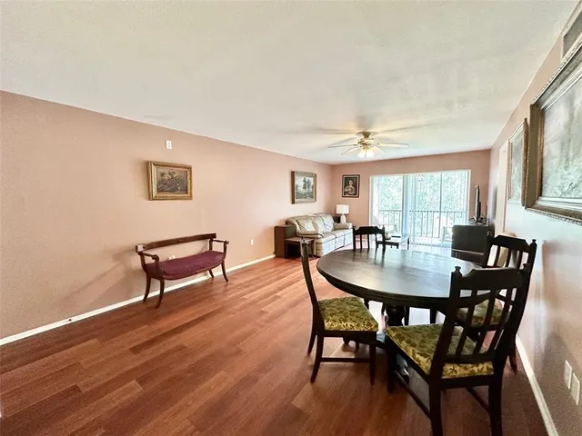 a view of a a dining room with furniture window and wooden floor