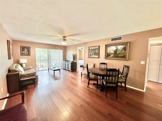 a view of a dining room with furniture window and wooden floor