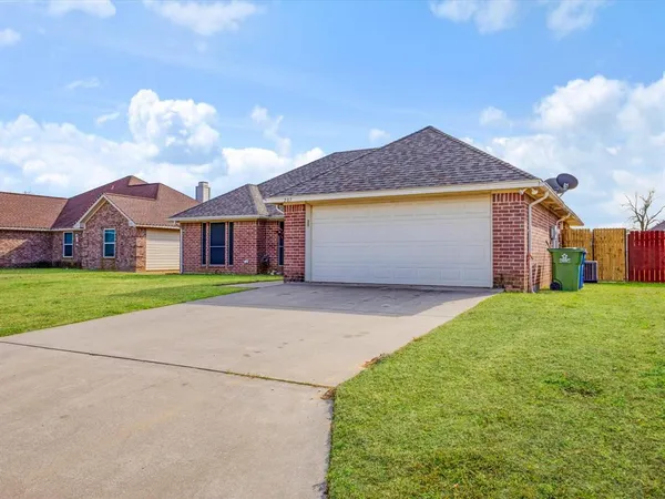 a front view of house with yard and garage