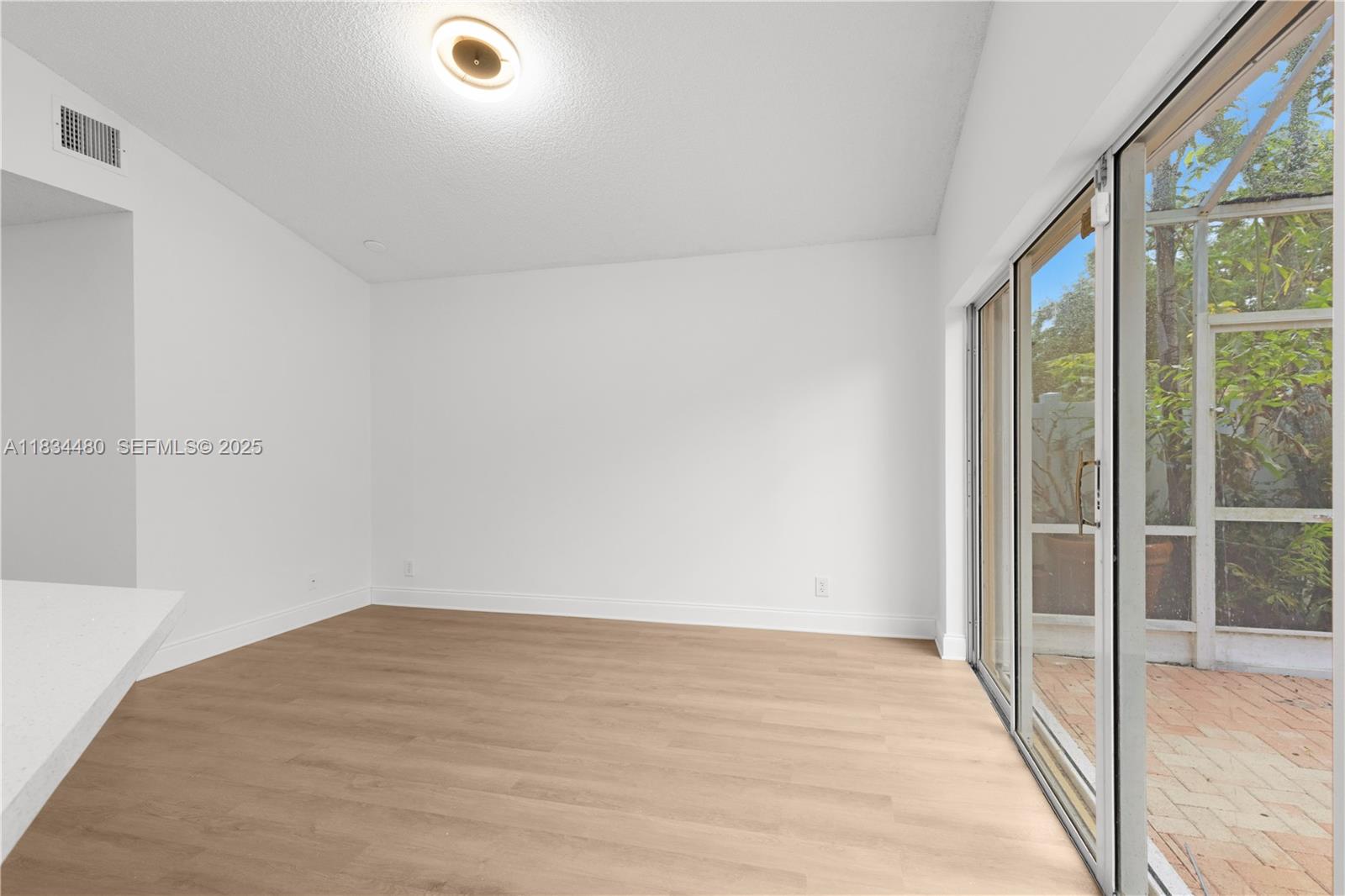 1525 Seabay Road Weston, FL 33326 - Photo 11 of 29 a view of a room with wooden floor and windows