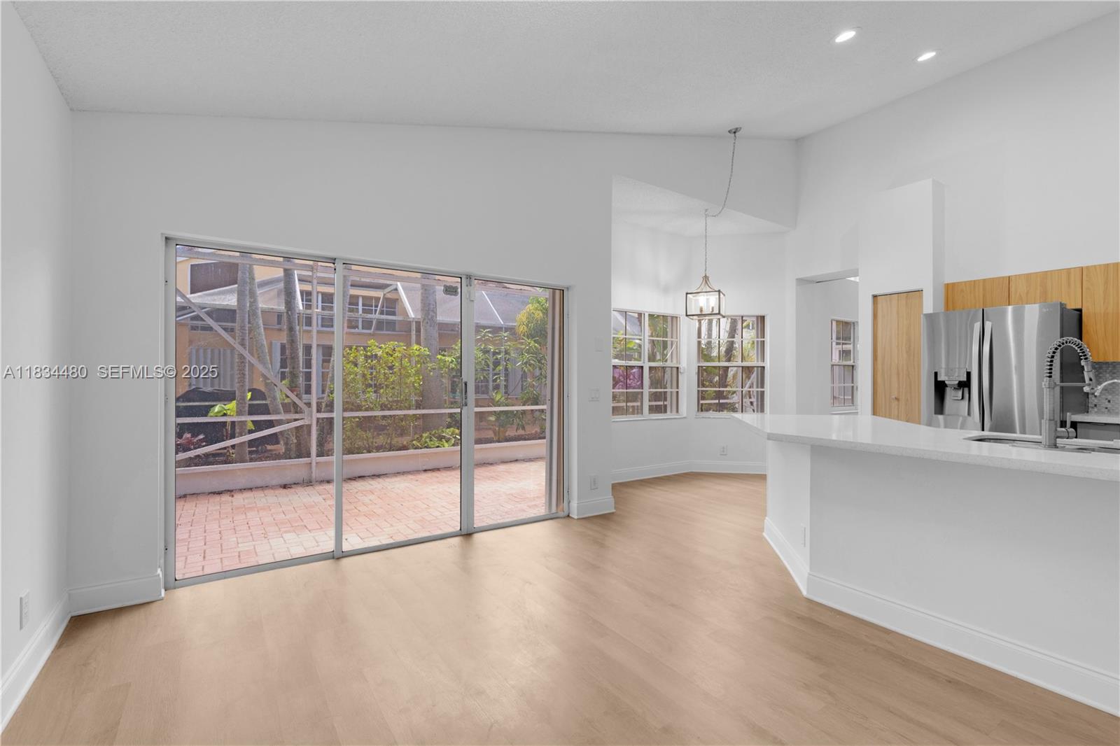 1525 Seabay Road Weston, FL 33326 - Photo 13 of 29 wooden floor in an empty room with a window