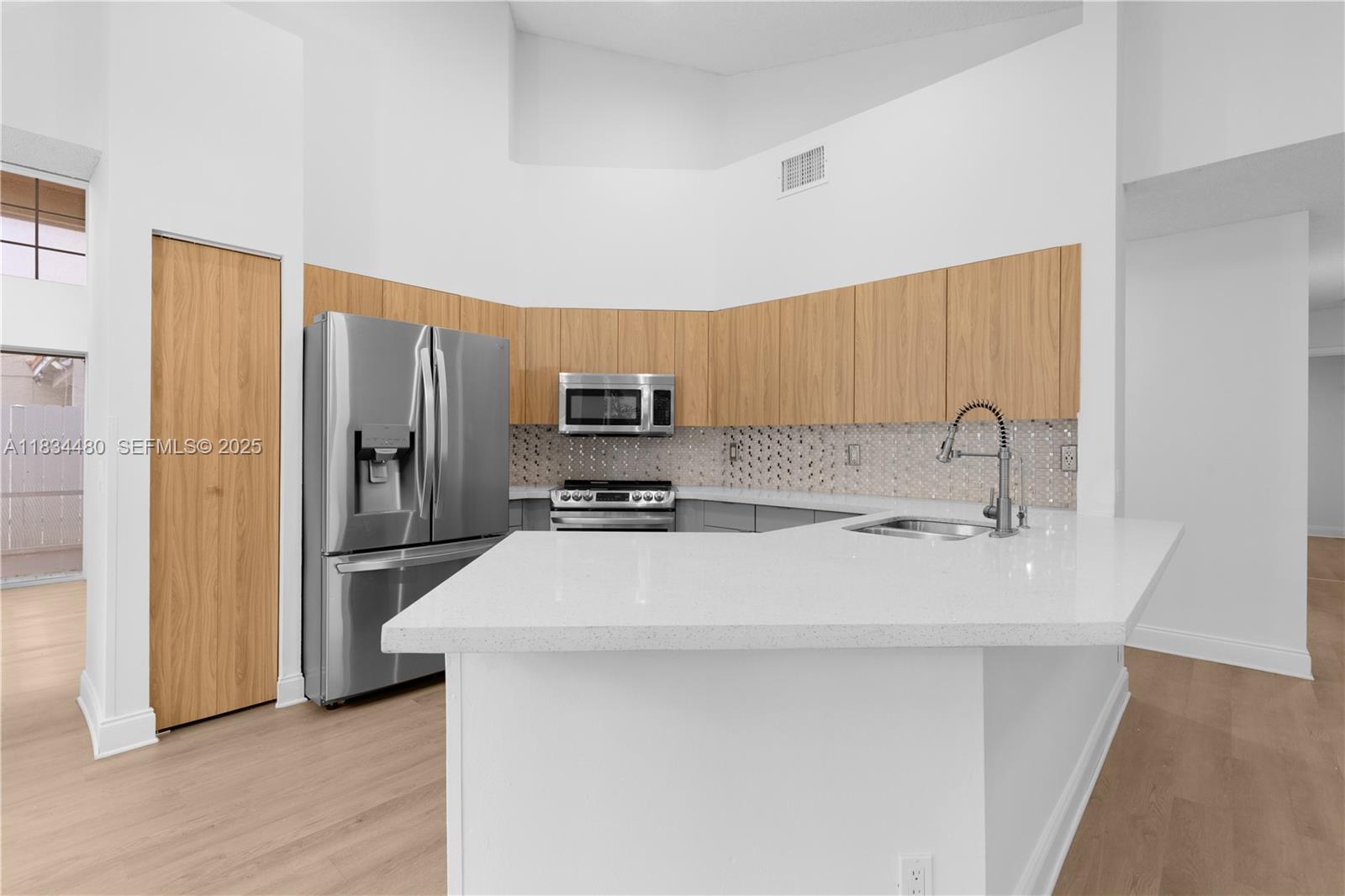 1525 Seabay Road Weston, FL 33326 - Photo 16 of 29 a kitchen with stainless steel appliances a refrigerator sink and microwave