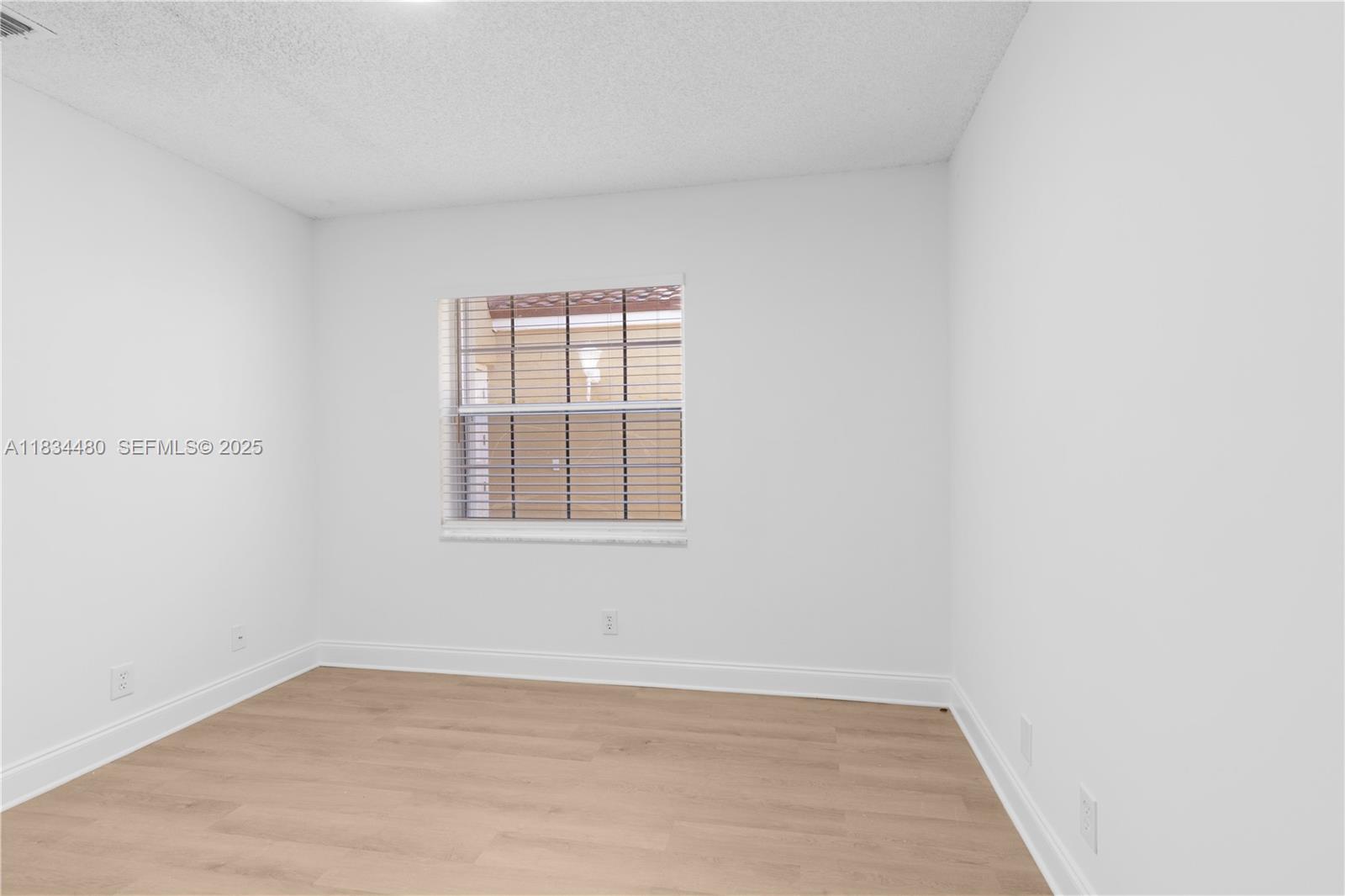 1525 Seabay Road Weston, FL 33326 - Photo 22 of 29 an empty room with a window