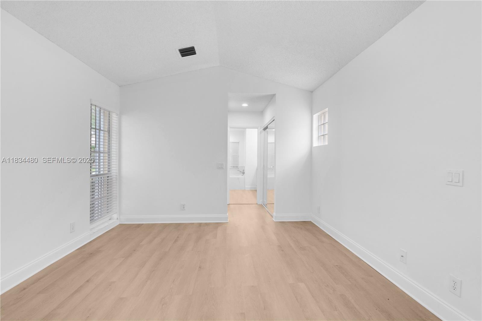 1525 Seabay Road Weston, FL 33326 - Photo 24 of 29 a view of an empty room with wooden floor