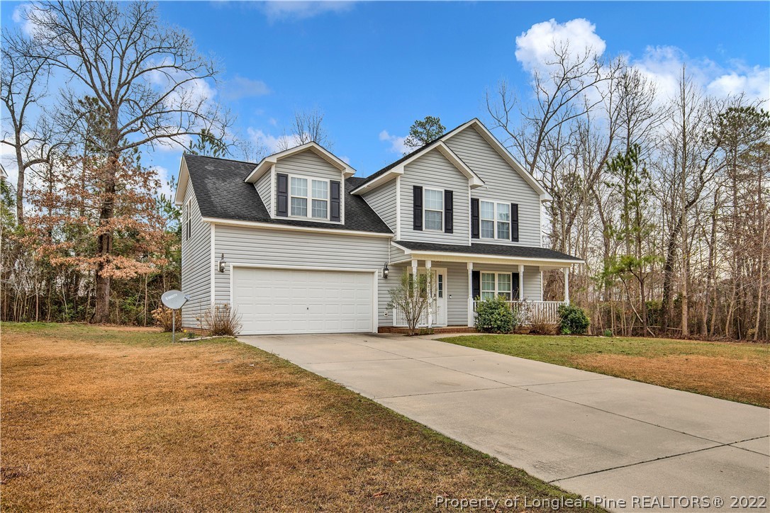 165 Pender Road Spring Lake, NC 28390 - Photo 2 of 33 a front view of a house with a yard and garage