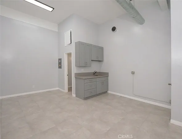 a kitchen with granite countertop a sink and a stove