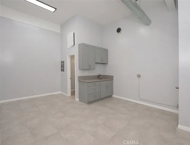 a kitchen with granite countertop a sink and a stove