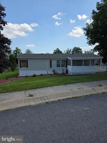 a front view of house with a garden