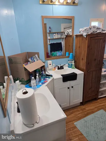 a white bath tub sitting next to a bathroom sink
