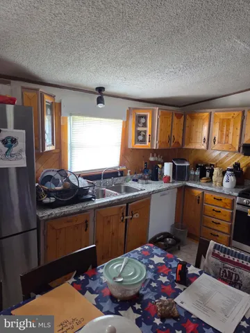a kitchen with appliances cabinets and a fireplace