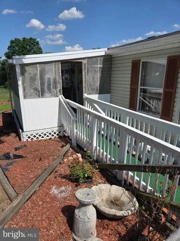 a view of a chair and tables in the balcony