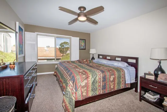 a bedroom with a bed and ceiling fan