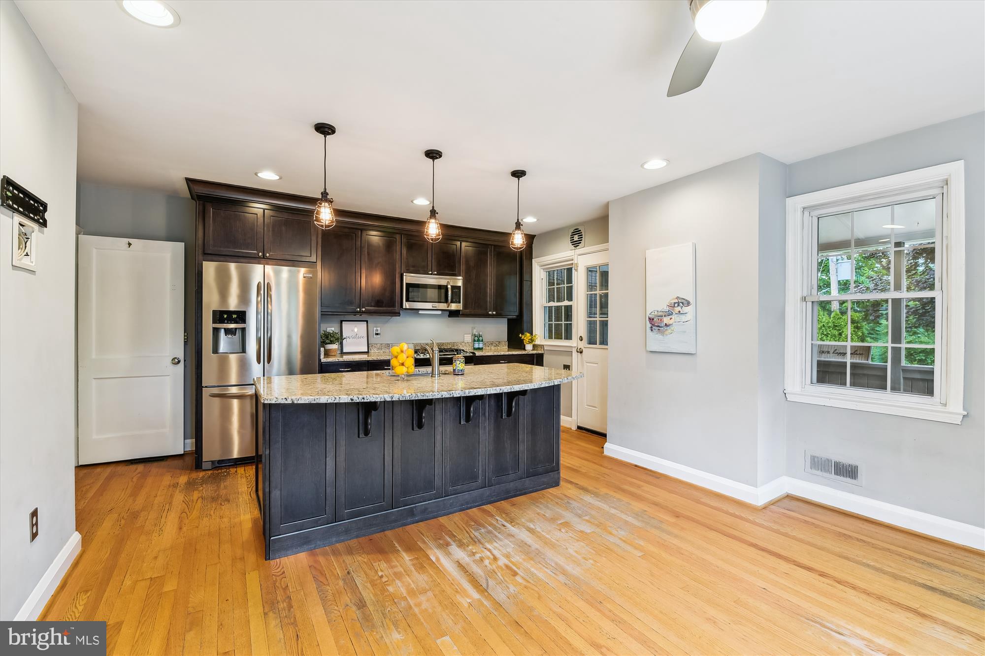 130 Stanmore Road Baltimore, MD 21212 - Photo 16 of 70 a kitchen with stainless steel appliances kitchen island granite countertop wooden floors and sink