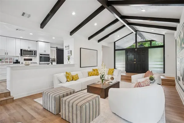 a bedroom with furniture and a large window