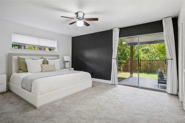 a bedroom with a bed and a large window