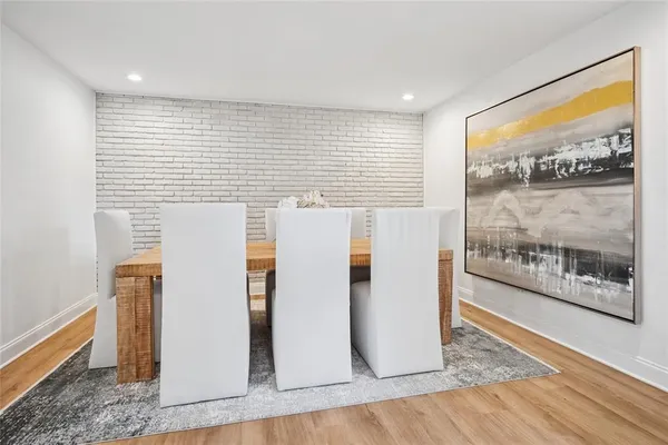 a view of a room with wooden floor and a refrigerator